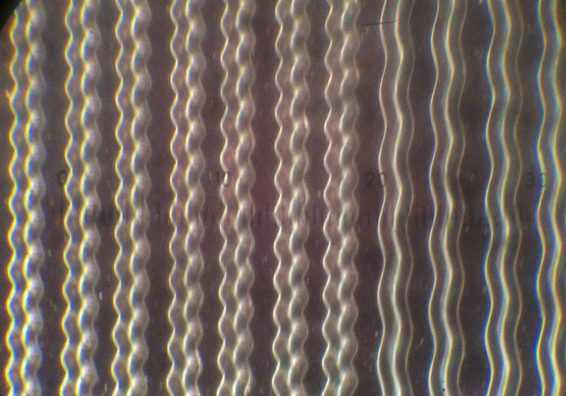Grooves on a lacquer disc as seen under a microscope.